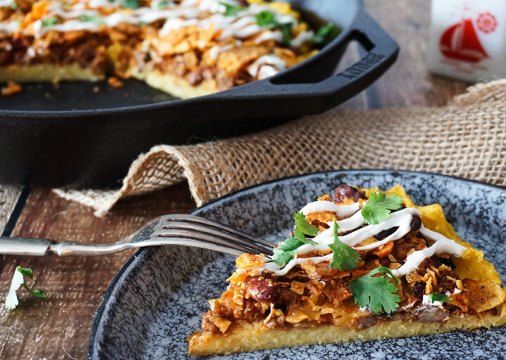 Chili Cheese Polenta; crispy-edged, creamy-centered polenta topped with chili, cheese, and crunchy crushed nacho chips. No one will ever guess that this chili cheese polenta is a frugal leftover makeover, unless you tell them that is!