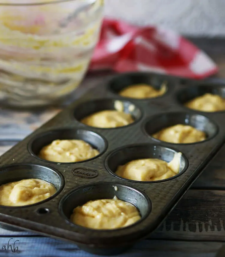 A muffin tin filled with cornbread batter, ready to pop into the oven. 