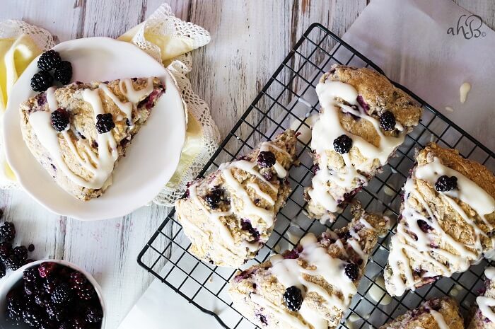 Tender and flaky scones are studded with sweet tart blackberries and topped with a rich cream cheese glaze.
