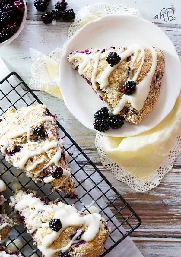 Tender and flaky scones are studded with sweet tart blackberries and topped with a rich cream cheese glaze for a winning combination.