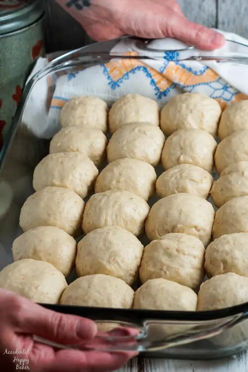 The oatmeal rolls are shaped and placed in a pan to rise again. 