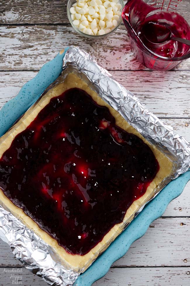 Next spread the raspberry jam over the shortbread cookie dough.