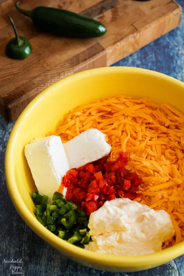 Sharp cheddar, cream cheese, may, pimentos and jalapenos in a bowl. 