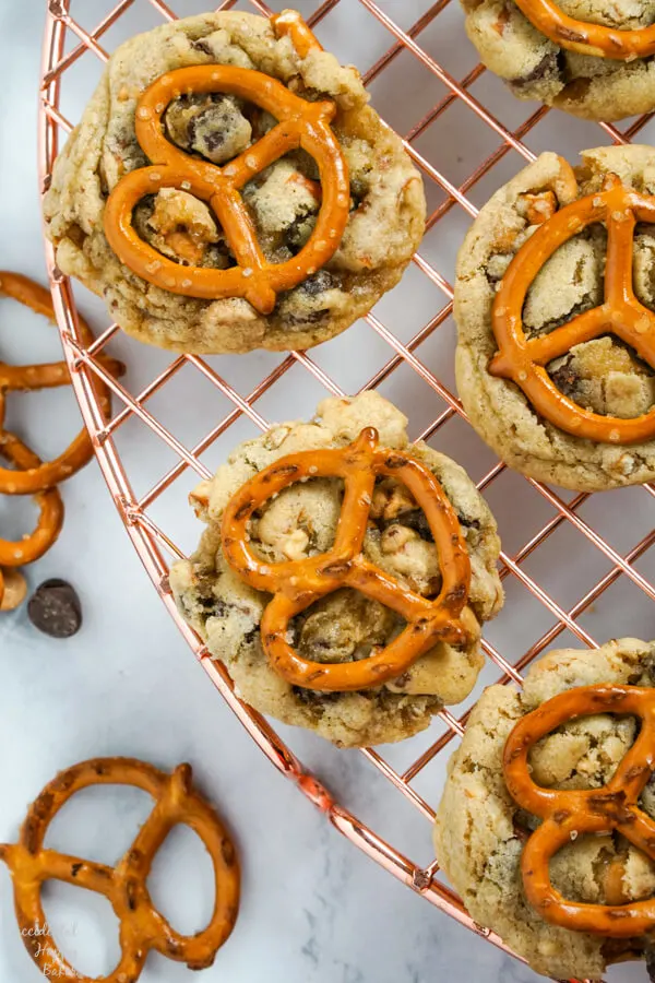 Peanut Butter Pretzel Chocolate Chip Cookies are set out on a cooling rack. 