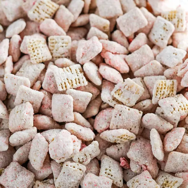 A closeup photo showing the pink cheesecake coating on the rice chex cereal. 