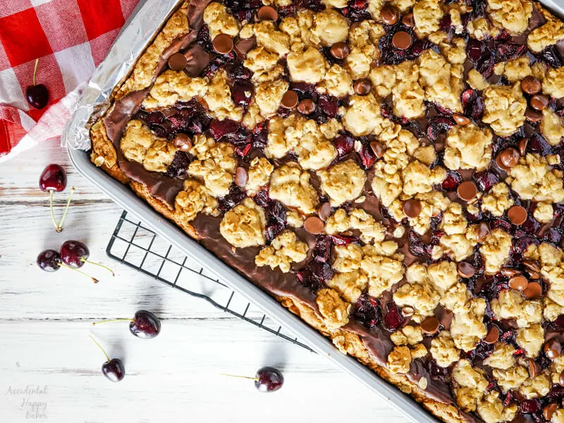 A pan of fresh baked cherry revel bars on a cooling tray. 