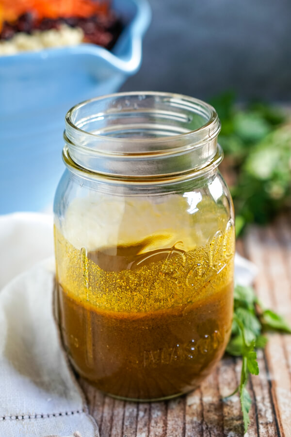 A mason jar with the mixed curry dressing.