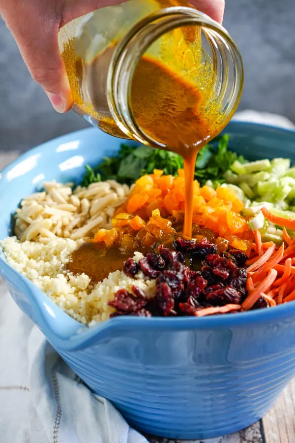 The curry dressing is poured over the top of the curried couscous salad. 