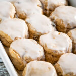 A close up on a baking pan full of cinnamon raisin biscuits.