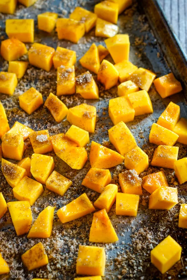A baking sheet full of bourbon and cinnamon butternut squash ready to be placed in the oven. 