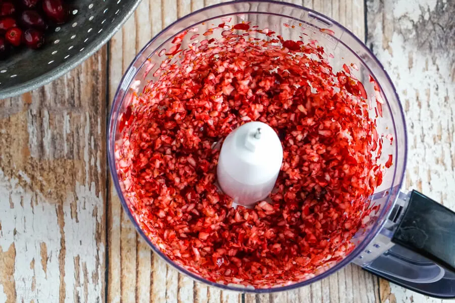 Finely chopped cranberries in the food processor bowl. 