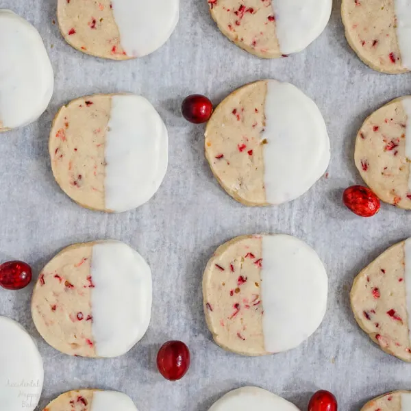 A sheet pan of finished cookies after they've been dipped in white chocolate. 