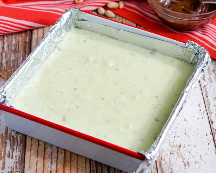 The hot pistachio fudge is poured into the pan.