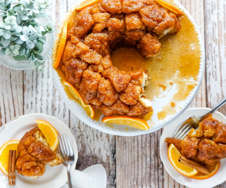 A large serving plate of Orange Spiced Monkey Bread and 2 small plates with servings.
