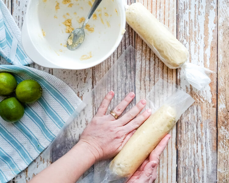 After the key lime pie shortbread cookie dough is made, it is shaped into logs and wrapped. 