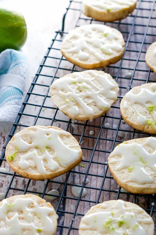 A wire rack full of glazed Key Lime Pie Shortbread Cookies