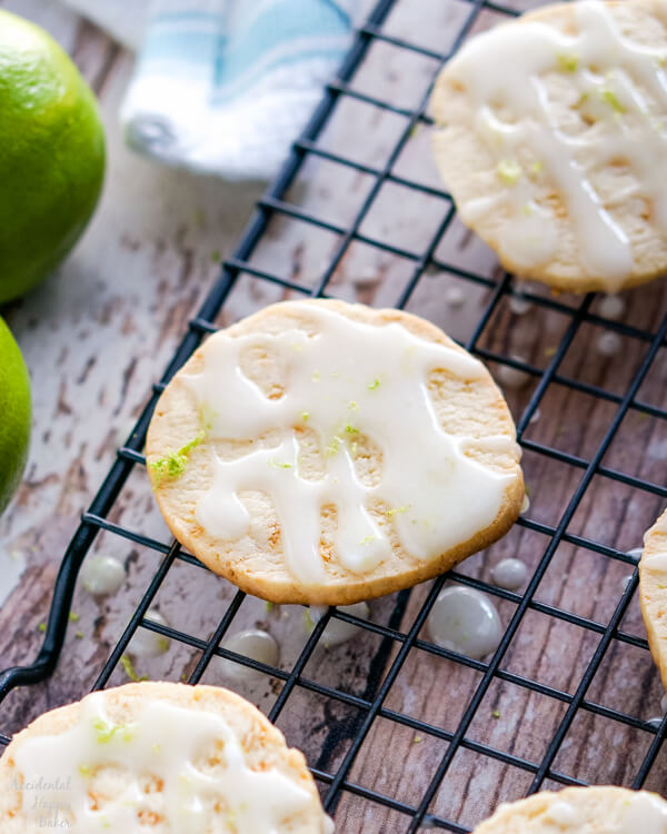 A wire rack full of glazed Key Lime Pie Shortbread Cookies