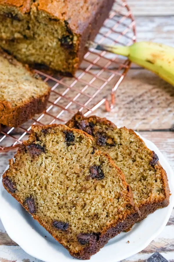 A close up of two slices of banana bread that show the chocolate chunks and the texture of the finished bread. 