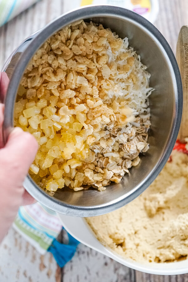 Adding the candied lemon peel, oats, coconut, and rice crispies to the cookie dough. 