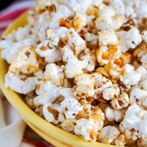 A close up of a yellow bowl full of Kettle Corn.