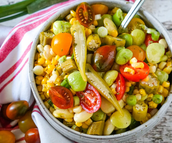 A bowl of Succotash Salad accented with slices of pickled okra.