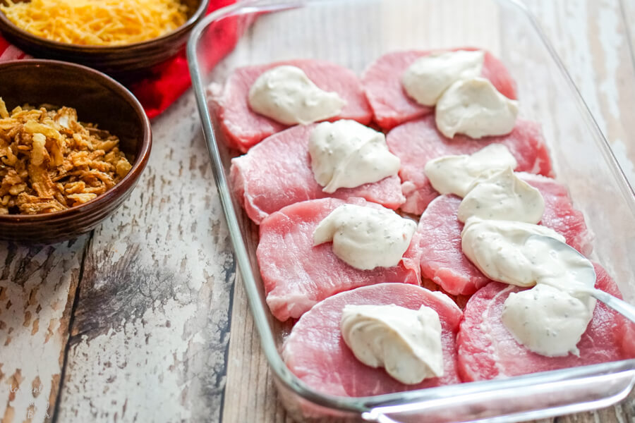 Sour cream dip is spread over the pork chops. 