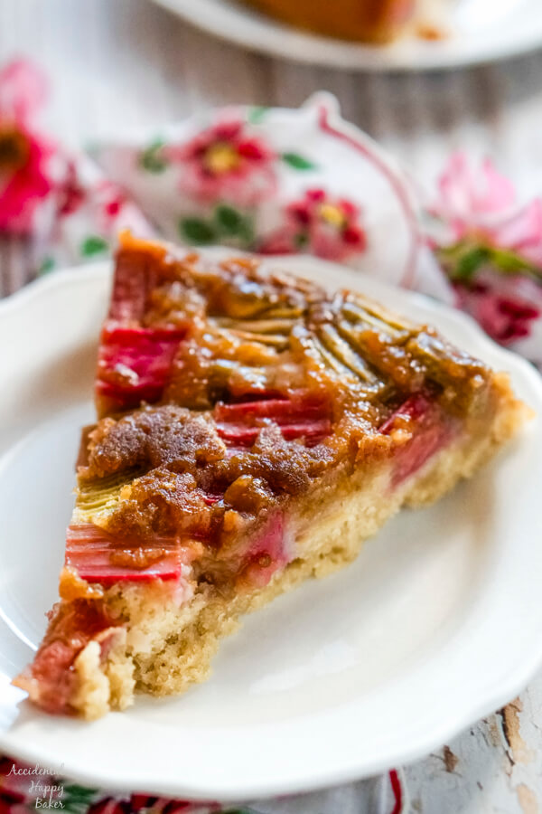 A slice of rhubarb ginger upside down cake on a white plate. 