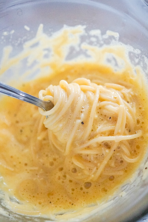 Hot cooked spaghetti is tossed in the egg mixture. 