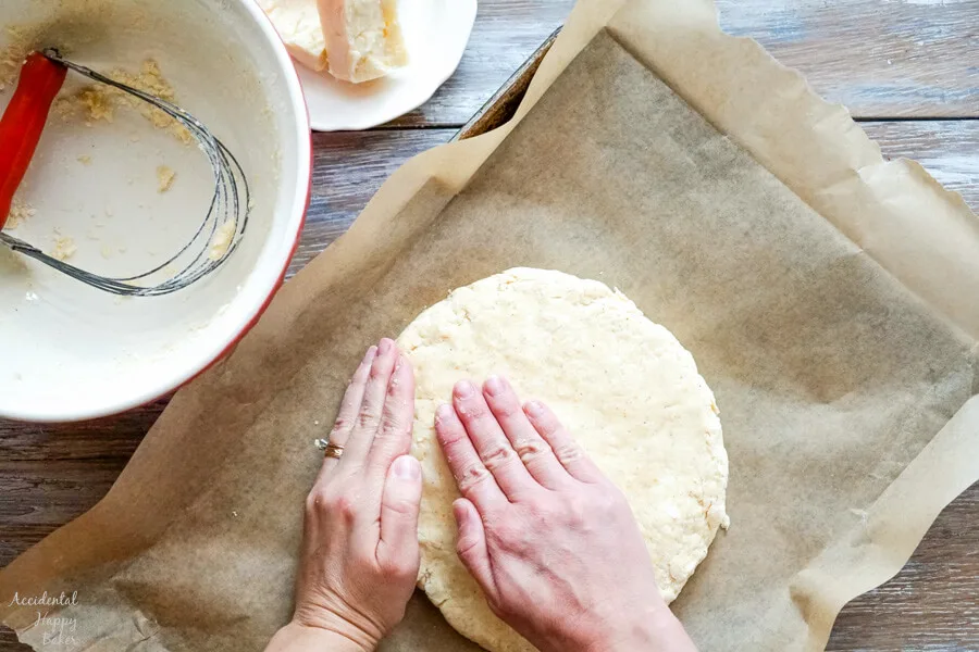 The scone dough is shaped into a round. 