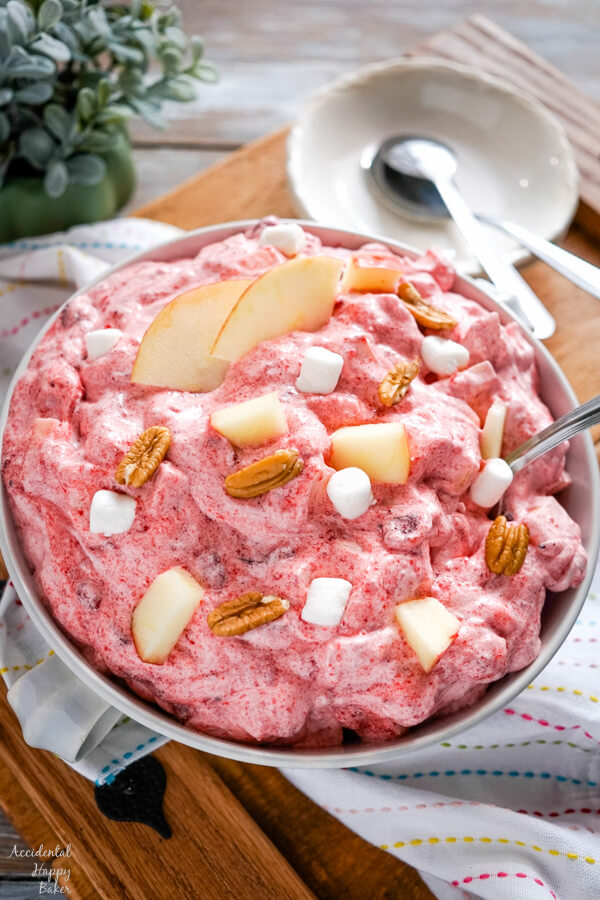A serving bowl of Cranberry Apple Fluff on a tray.