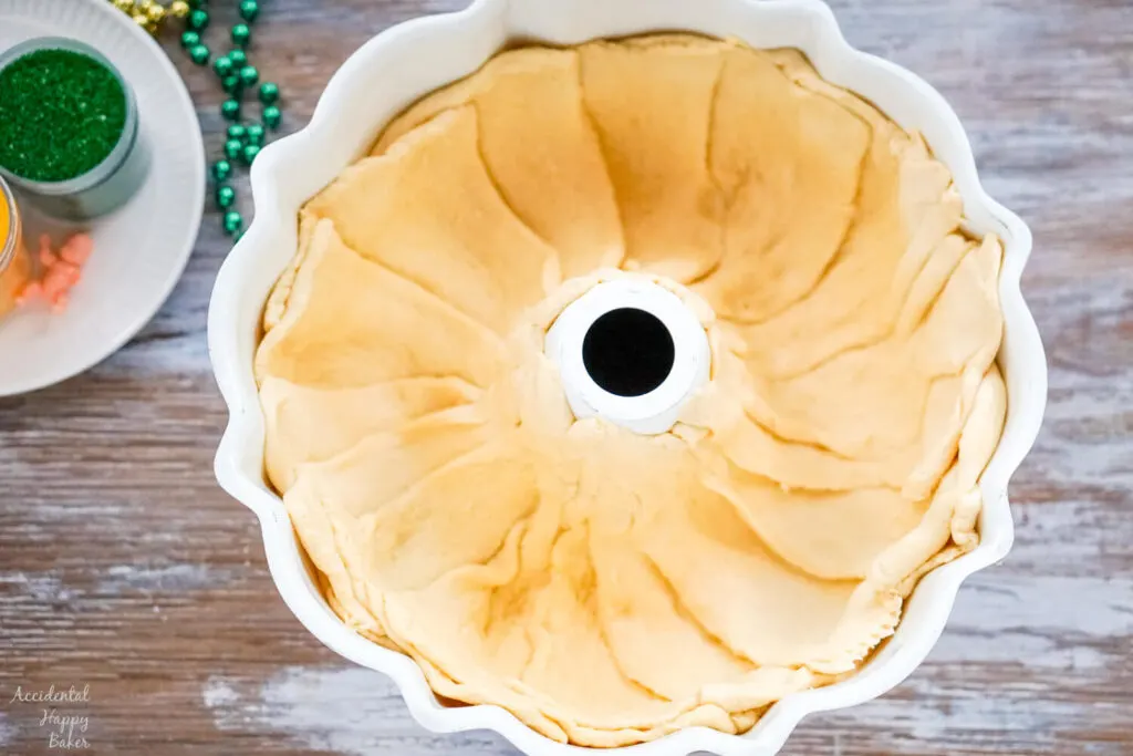 Crescent rolls are pressed into a bundt pan. 