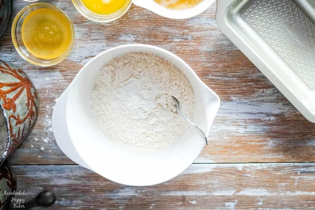 All-purpose flour, baking powder, and salt are added to the mixing bowl.