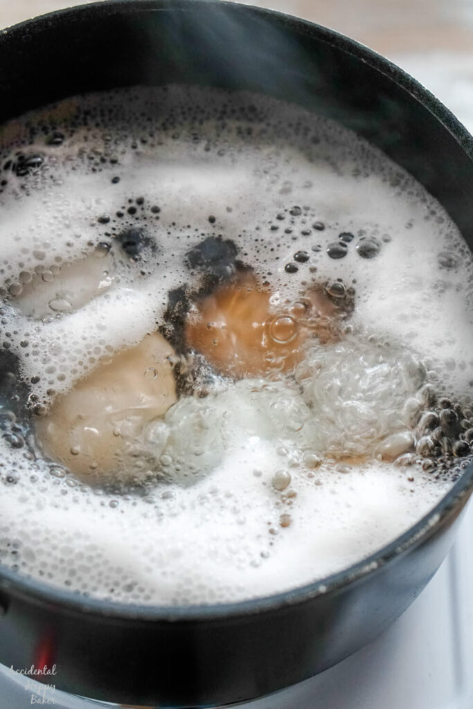 A pan of eggs in boiling water.