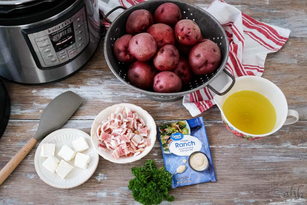 The ingredients needed to make instant pot ranch potatoes siting next to the instant pot. 