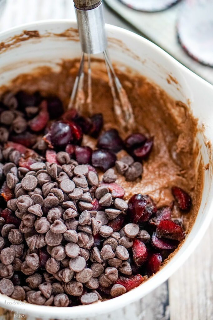 Chopped cherries and chocolate chips are whisked together.