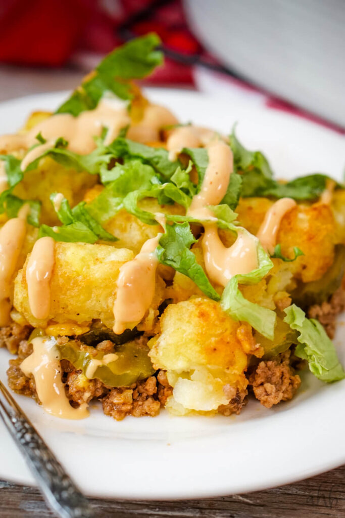 Big Mac Tater Tot Casserole topped with freshly shredded lettuce and Thousand Island dressing.