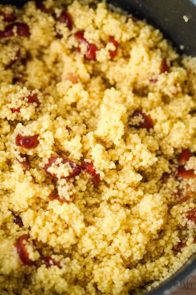 Cooked couscous mixed with the dried cranberries, cinnamon, cardamom, and cumin.