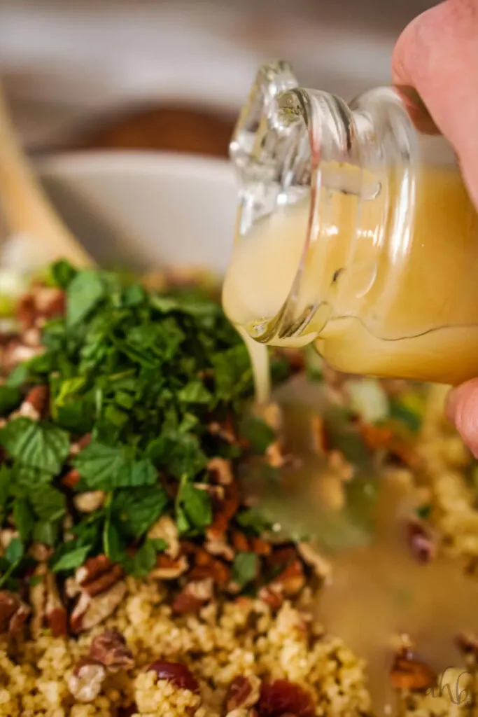 The homemade dressing is drizzled over the top of the Cranberry Couscous Salad.