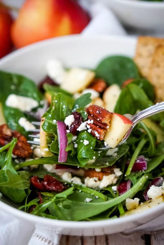A forkful of Apple Feta Spinach Salad. 