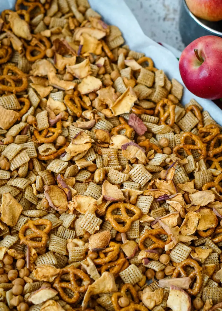 The apple chips and the caramel chips are added into the cooled cereal mixture.