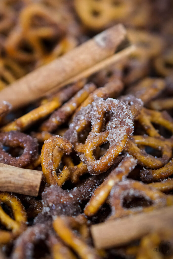 A closeup of Cinnamon Sugar Pretzels with cinnamon sticks.