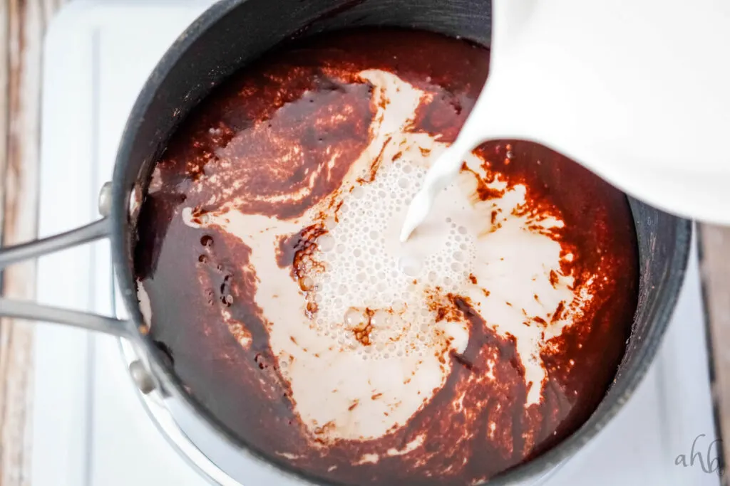 Milk is poured into the sauce pan and mixed with the syrup base. 
