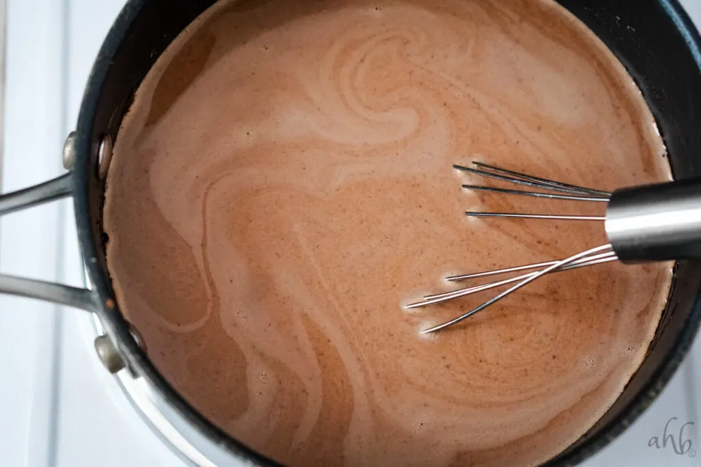 Extract is whisked into the hot chocolate.