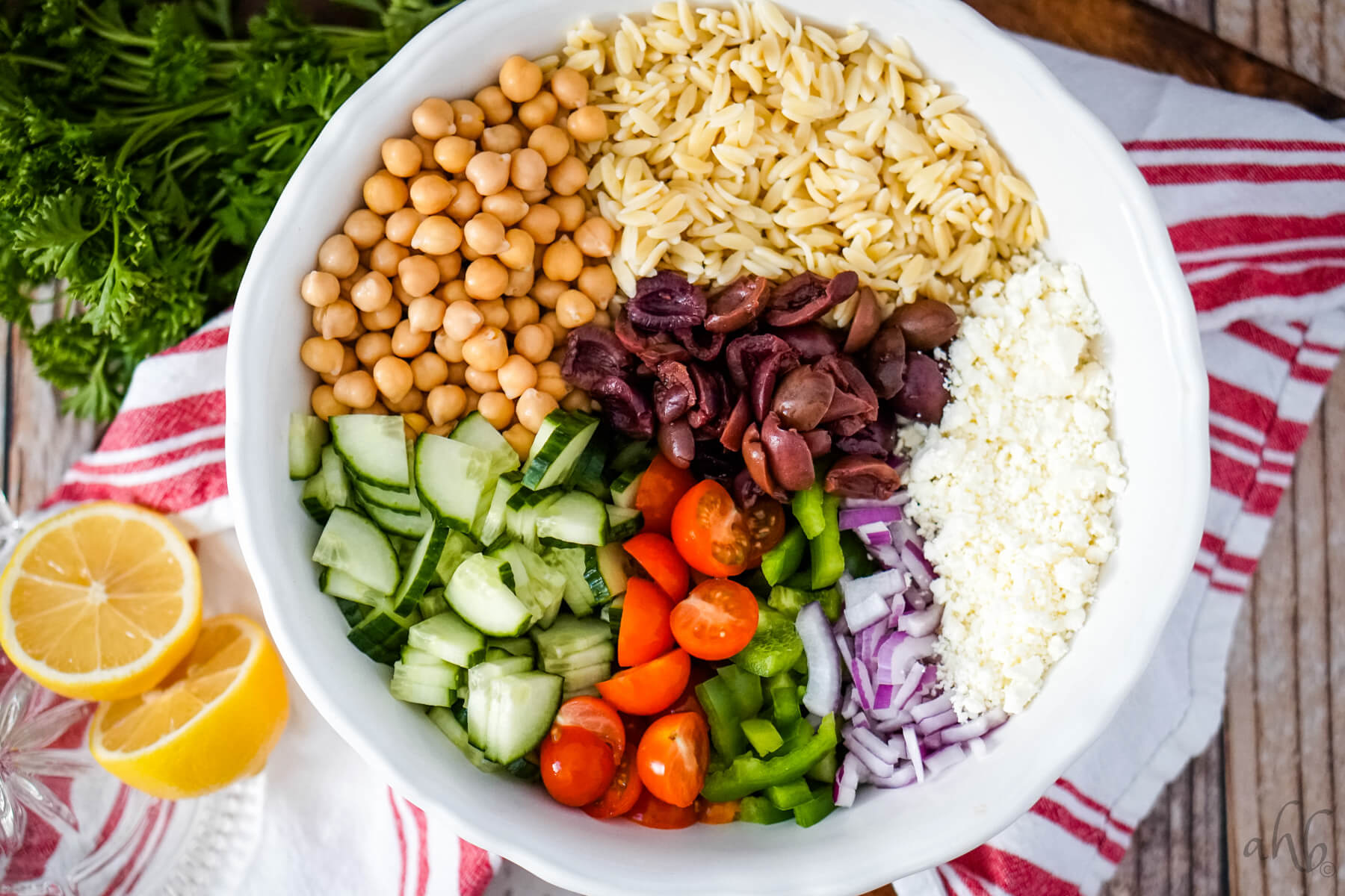 A large white bowl is filled with all the ingredients for the salad.